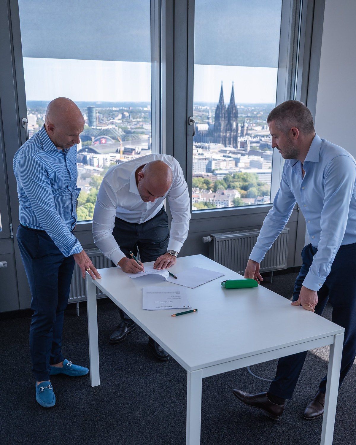 Die geschäftsführenden Gesellschafter von Angermann NRW im KölnTurm, im Hintergrund der Kölner Dom